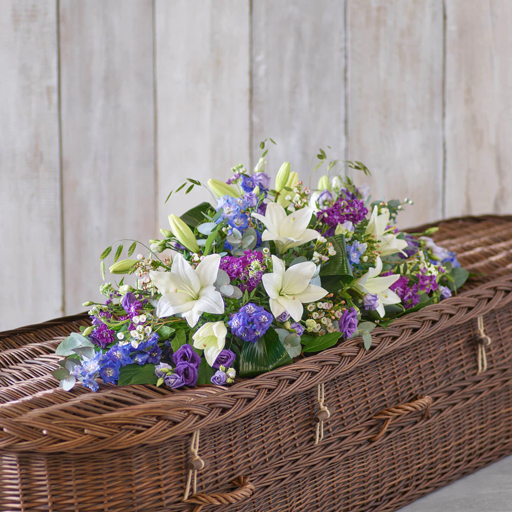 ‘The Flower Shop Helensburgh - Blue And White Casket Spray’